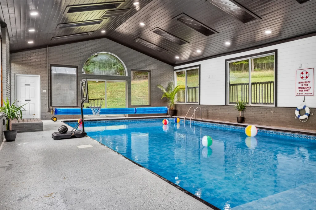 Indoor pool with skylights and basketball hoop at The Onyx at Luray