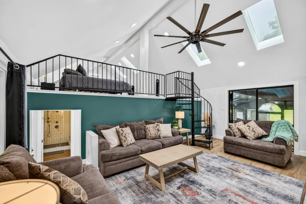 Living room with vaulted ceiling and loft above